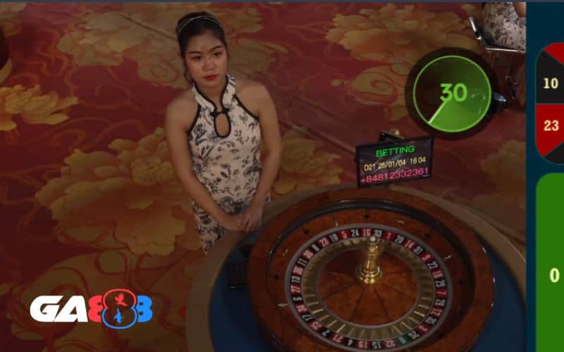 Giao diện roulette online có dealer đứng bên vòng quay Giao diện roulette online có dealer đứng bên vòng quay